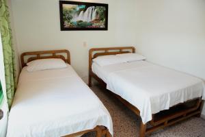 Letto o letti in una camera di Hotel Casa Verde Guatapé