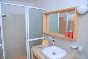 a bathroom with a white sink and a shower at Destine Holiday Bungalow in Galle +12 photos