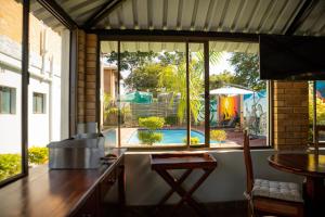 a kitchen with a view of a pool through a window at Amakhosi Hotel in Victoria Falls