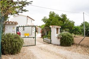 a gate in front of a house with bushes at Villa del Lupo in Santa Maria la Palma