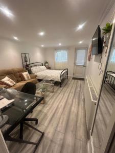a living room with a couch and a bed at Adorable 1-bedroom entire place with free parking in Cambridge