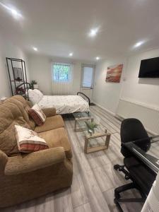 a living room with a couch and a piano at Adorable 1-bedroom entire place with free parking in Cambridge +2 photos