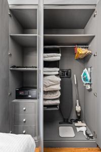 a bedroom with a closet with a desk and towels at Luxury studio at JLT near metro in Dubai