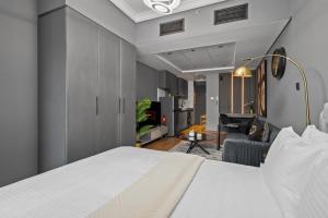 a bedroom with a bed and a living room at Luxury studio at JLT near metro in Dubai