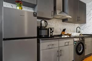 a kitchen with a refrigerator and a washing machine at Luxury studio at JLT near metro in Dubai