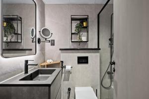 a bathroom with a sink and a shower at Luxury studio at JLT near metro in Dubai