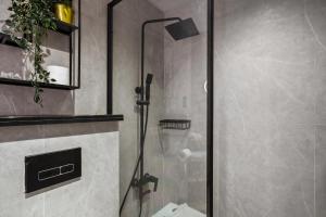 a shower with a glass door in a bathroom at Luxury studio at JLT near metro in Dubai