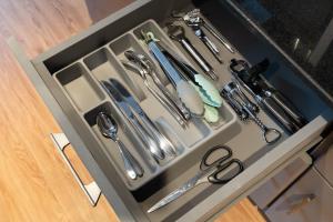 a drawer filled with utensils in a kitchen at Luxury studio at JLT near metro in Dubai