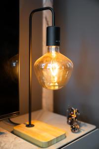 a glass lamp sitting on a table in a room at Luxury studio at JLT near metro in Dubai