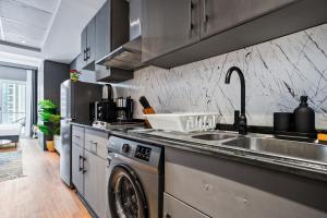 a kitchen with a sink and a washing machine at Luxury studio at JLT near metro in Dubai