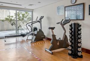 a gym with cardio machines in a room at Luxury studio at JLT near metro in Dubai