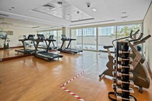 a gym with a bunch of exercise bikes in it at Luxury studio at JLT near metro in Dubai