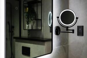 a mirror is attached to a wall in a bathroom at Luxury studio at JLT near metro in Dubai