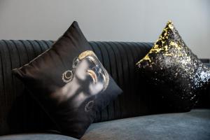 two pillows with a picture of a woman on a couch at Luxury studio at JLT near metro in Dubai