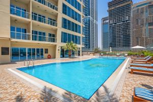 a swimming pool in the middle of a building with tall buildings at Luxury studio at JLT near metro in Dubai