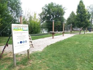 a sign in a park with a playground at Au son de l'eau in Birac