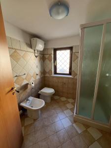 a bathroom with a toilet and a sink and a shower at Sweet home Rosarno in Rosarno +21 photos