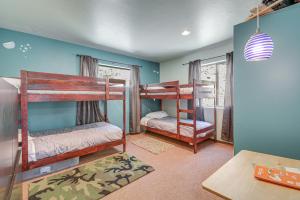 a room with three bunk beds in it with a table at 6 Mi to Mt Union Peaceful Cabin with Deck in Mayer
