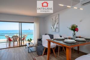 a dining room and living room with a view of the ocean at Apartament Made in Costa Brava in Sant Antoni de Calonge +15 photos