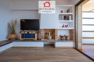 a living room with a tv on a table at Apartament Made in Costa Brava in Sant Antoni de Calonge