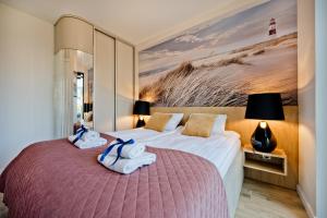 a hotel room with two beds with towels on them at BlueApart Jeżynowa Jastarnia in Jastarnia