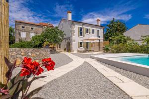 a home with a swimming pool and a house at Holiday house Rural home Frane in Kornić