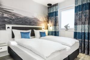 Postel nebo postele na pokoji v ubytování Meerblickvilla Großenbrode Wohnung 21 + 17 fotografií