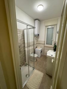 a bathroom with a shower and a toilet and a sink at Casa Facetti presso HOTEL KRISTALL in Diano Marina