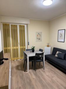 a living room with a table and a couch at Casa Facetti presso HOTEL KRISTALL in Diano Marina