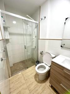 a bathroom with a shower and a toilet and a sink at Casa El Verano in Puerto de Mogán +8 photos