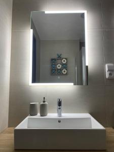a white sink in a bathroom with a mirror at Nad Soutokem in Volary +47 photos
