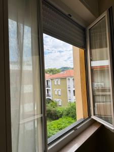 a window with a view of a building at Casa Facetti presso HOTEL KRISTALL in Diano Marina +11 photos