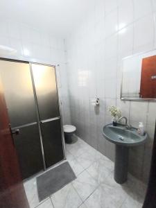 a bathroom with a shower and a sink and a toilet at Studio 01 Quarto 3 in São José dos Campos