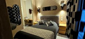 a bedroom with a bed and a tv on the wall at Mei Hôtel-Restaurant in Sarrebourg