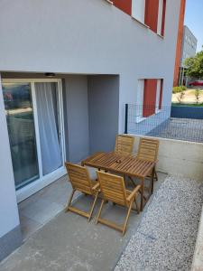 a wooden table and chairs sitting on a patio at Apartment Nikolaj in Labin