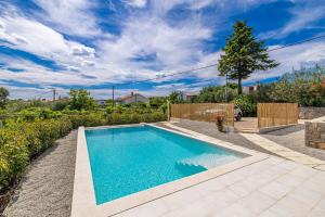 a swimming pool in the backyard of a home at Holiday house Rural home Frane in Kornić +24 photos