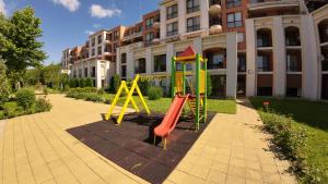 a playground in front of a building at William's apartments - second cozy studio in Sveti Vlas