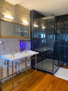 a bathroom with two sinks and a shower at Chateau de Montcuquet in Lautrec +23 photos