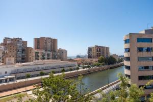 a view of a city with a river and buildings at BUBU Apartments By Charming Stay in Málaga