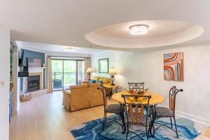 a living room with a table and chairs and a couch at Cozy Smoky Mtn 2br Getaway W Pool Fireplace in Gatlinburg