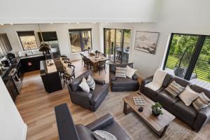 a living room with couches and a dining room at Private Pool, Dog Friendly, Theater, Game Room! in Sevierville
