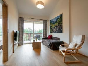 a living room with a couch and a tv at Apart33 Top 2-15 in Haus im Ennstal