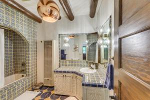 a bathroom with a sink and a mirror at Mid-Century Modern Taos Home with Hot Tub and Fire Pit in Taos +18 photos