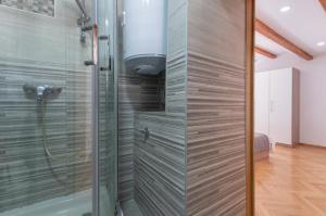a shower with a glass door in a bathroom at Top Center in Split +99 photos