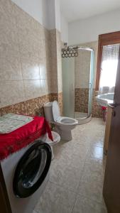 a bathroom with a toilet and a shower and a sink at visitShkoder - Noel's Home in Shkodër