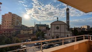 a view of a building with a clock tower at visitShkoder - Noel's Home in Shkodër +2 photos