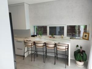 a kitchen with a island with bar stools at Big Mama Koala in Druskininkai