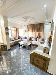 a living room with a couch and a table at Apartamento con vistas al mar 3 in Al Hoceïma