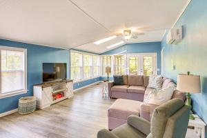a living room with two couches and a tv at Bayfront Steuben Home with Screened Porch and Fire Pit in Steuben