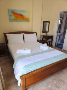 a bedroom with a bed with two towels on it at Natura Studios in Andipáta Erísou